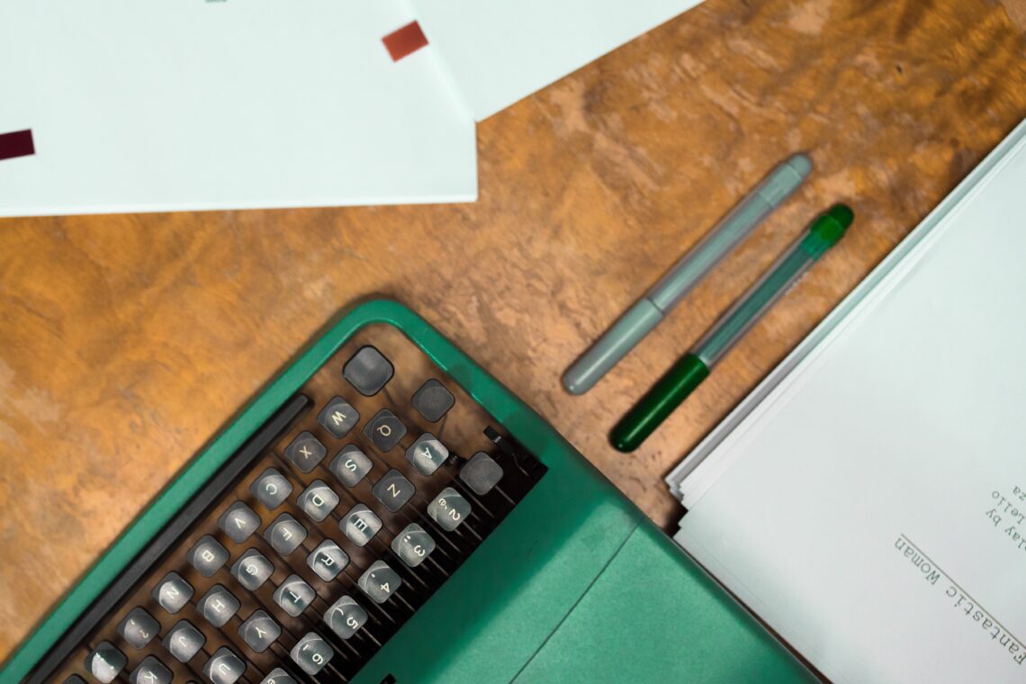 Title Image of Typewriter, Pens, and Paper.